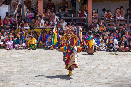 Paro,Bhutan-Apr 4,2015;Buddhist lama performs mask dance in front of Bhutanese people in beautiful traditional costume at Rinpung Dzong during Paro Tshechuのeditorial素材