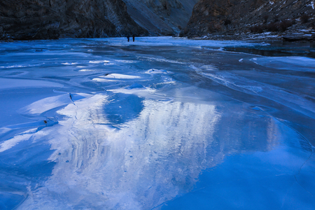 Reflection of mountain on the surface of frozen Zanskar river during chadar trek in Leh,Ladakh,Kashmir,Indiaの写真素材