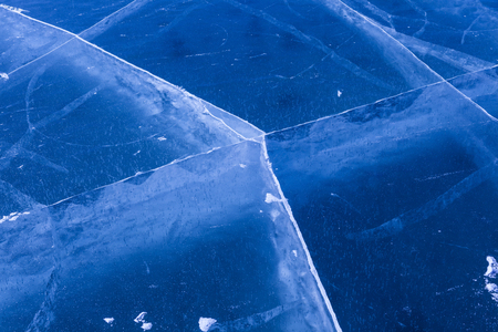 Crack lines network on thick frozen surface of Baikal lake near Shaman rock at Olkhon island,Siberia,Russia.Using to show transformation change of water by temperature.の写真素材