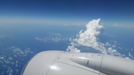 white jet engine in flight with blue skiesの写真素材