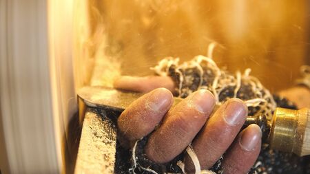 Woodworker cuts wood by chisel.Carpenter handles wood by lathe. Builder works with workpiece in...