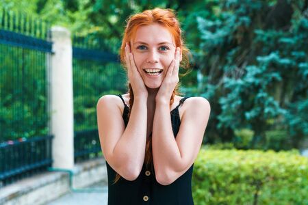 Girl with nordic appearance show emotions outdoor. Woman on blurred green background.の写真素材