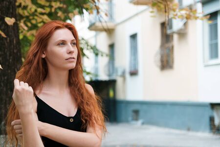 Ginger woman with long hairs in hand, close up.の写真素材
