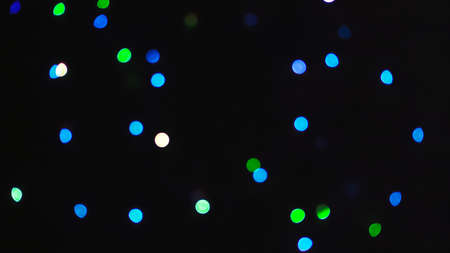 Dark background with blurred colorful bokeh.の写真素材