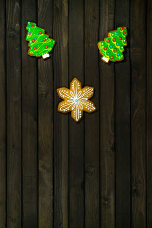 Christmas pattern with copy space. Gingerbread cookies dark on wooden background.の写真素材