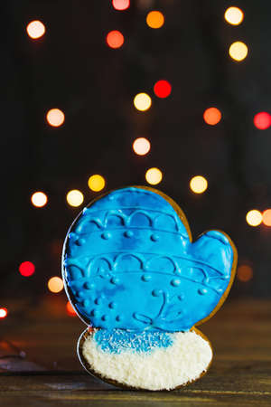 Gingerbread in shape of Christmas mitten. Cookie on blurred background, soft focus.の写真素材