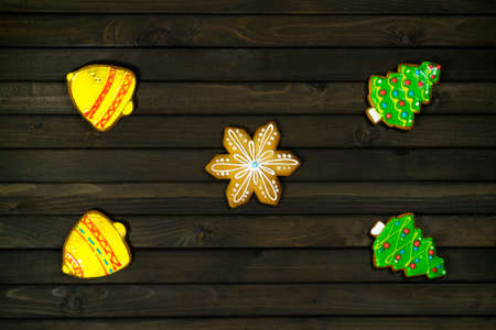 Holiday concept. Gingerbread cookies dark on wooden background. Christmas time.