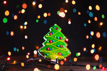 Gingerbread in shape of fir-tree. Cookie on blurred background, soft focus.の写真素材