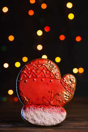 Gingerbread in shape of mitten. Christmas cookie on blurred background, soft focus.の写真素材