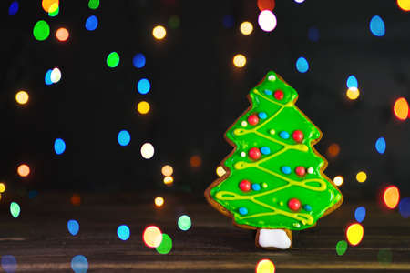 Gingerbread in shape of Christmas tree. Cookie on blurred background, soft focus.の写真素材