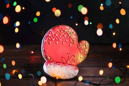 Gingerbread in shape of Christmas mitten. Cookie on blurred background, soft focus.の写真素材