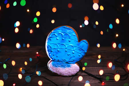 Gingerbread in shape of Christmas gantlet. Cookie on blurred background, soft focus.の写真素材