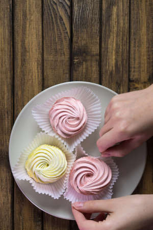 Table decoration for festive dinner. Meringue on plate, space for text.の写真素材