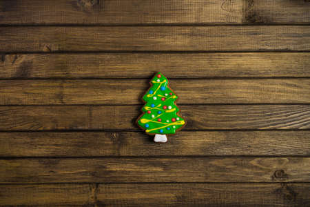 Christmas pattern with copy space. Festive mood. Gingerbread cookie on wooden background.の写真素材