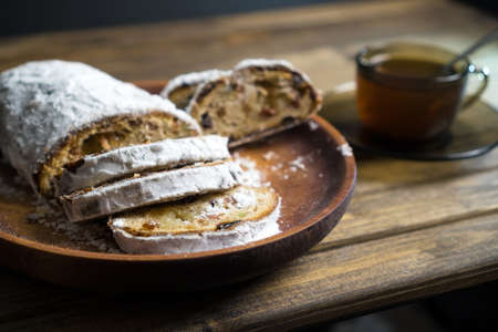 Bake with cup of tea on wooden table. Rustic dessert, soft focus.の写真素材