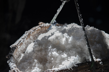 Salt in a wooden basket tied with a light rope.の写真素材