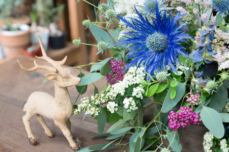 Eryngium planum Blue Sea Holly in flowers background with deer ceramic plasterの写真素材
