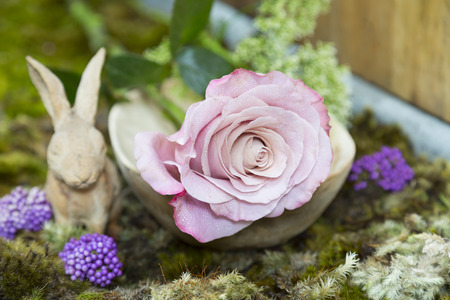 still life with pink of rose and Rabbit ceramic plaster on moss groundの写真素材