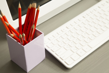 RED pencil on the table with computerの写真素材