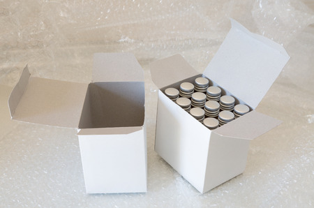 Medicine bottles in white paper box and air bubble