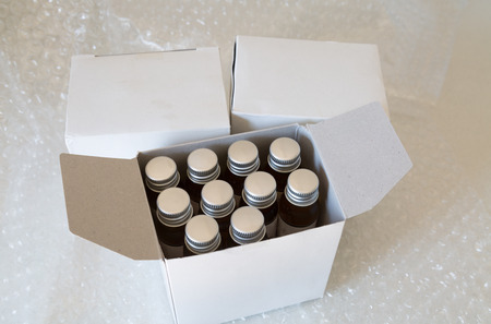 Medicine bottles in white paper box and air bubbleの写真素材