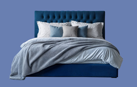 Cozy blue bed with bright  bedding  isolated on backgroundの写真素材