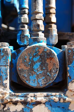Industrial machinery detail. Rusty metal texture with peeled paint.