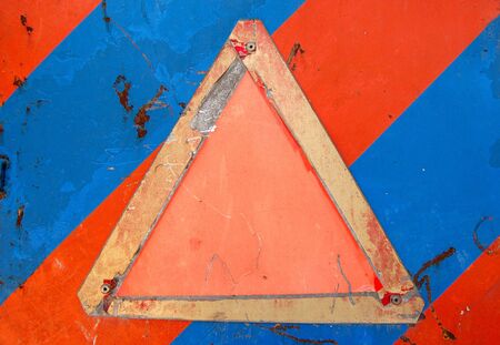 Weathered warning sign against an industrial metal surface. Scratched paint and rust background. Place your own text.の写真素材