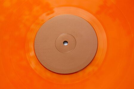 Colored orange vinyl record detail. Abstract background.の写真素材