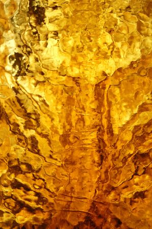 Yellow stained glass reflections golden texture. Abstract background pattern.の写真素材