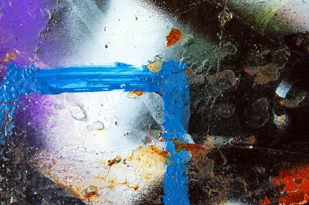 A metal surface covered with graffiti. Paint spray abstract background.の写真素材