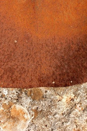 Rusty sheet of metal covering the opening of an old stone well.
