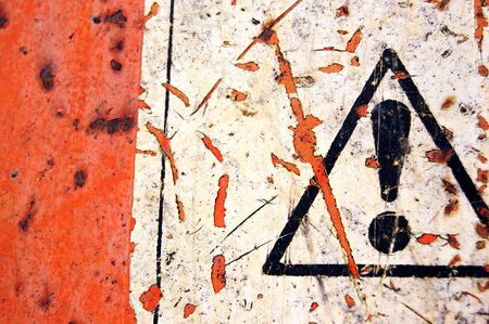 Rusty metal surface and weathered warning sign background.の写真素材