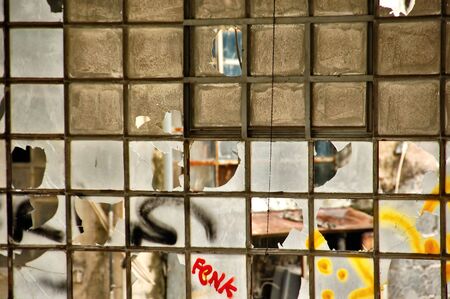 Broken windows in a partially demolished abandoned factory.の写真素材