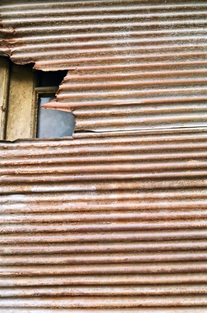 Weathered rusty roll down corrugated metal shutter texture.の写真素材
