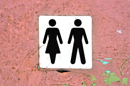 Male female symbol label on grungy wood background texture.の写真素材