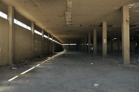 Dirty floor concrete wall and ceiling in abandoned factory. Industrial architecture.の写真素材