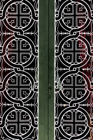 Tangled circles and cross christian religious icon pattern detail on iron church door.の写真素材