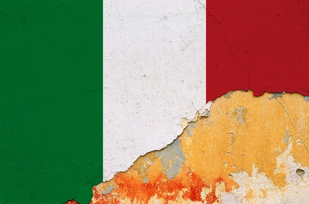 Italian flag painted on cracked smudged wall. Chipped paint grunge background.の写真素材