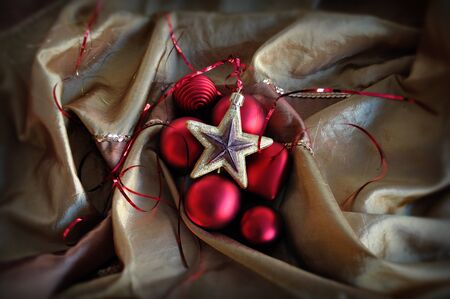 Red baubles and golden star. Christmas ornaments background.の写真素材
