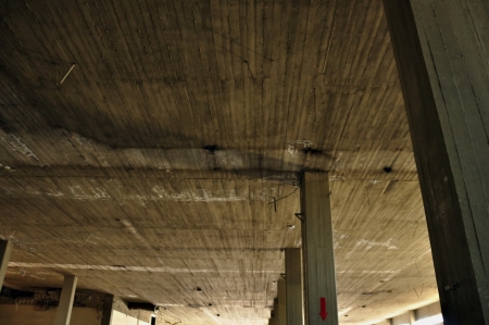 Concrete ceiling and pillars in abandoned factory interior. Industrial architecture.の写真素材