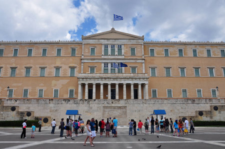 ATHENS, GREECE - JUNE 9, 2014: People visiting the greek parliament in Syntagma square. Tourists taking photos with the evzone soldiers guarding the tomb of the unknown soldier.のeditorial素材