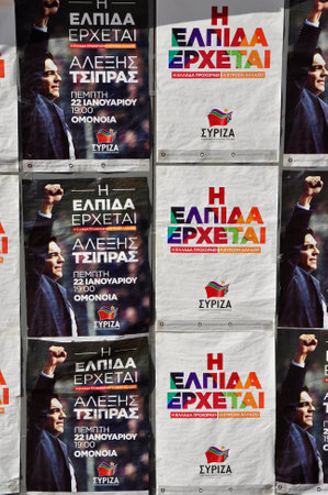 ATHENS, GREECE - JANUARY 28, 2015: Posters for anti-austerity political party Syriza - Coalition of the Radical Left which won the January 25, 2015 greek national elections. Portrait of Alexis Tsipras prime minister of Greece and electoral campaign sloganのeditorial素材