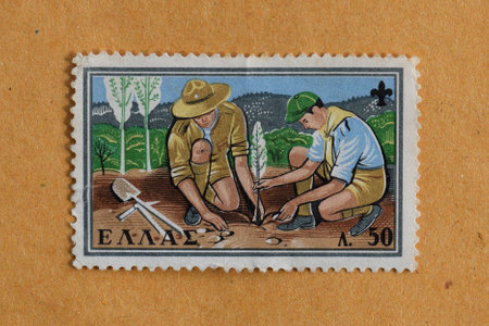 GREECE  CIRCA 1960: Two boy scouts planting a tree illustration on vintage postage stamp printed by the Hellenic Post.のeditorial素材