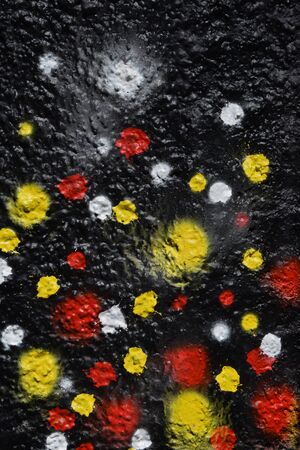 Colorful spray painted dots on textured wall abstract background.の写真素材