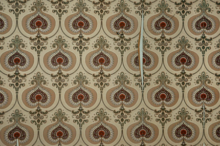 Vintage torn and dirty wallpaper with old fashioned pattern. Abstract retro background.の写真素材