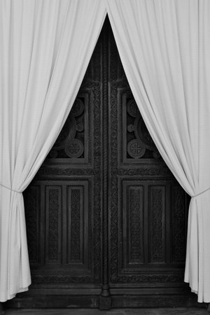ATHENS, GREECE - APRIL 27, 2015: Antique wooden carved gate and drapes during repairs at the Metropolitan Cathedral of Athens, Greece. Black and white.のeditorial素材