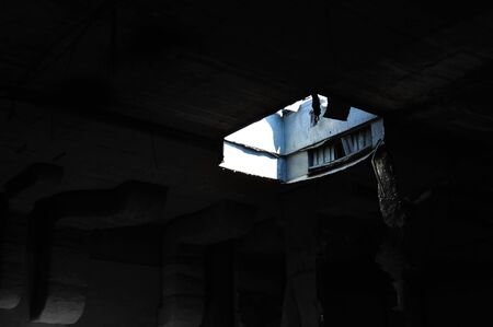 Ceiling skylight in dark abandoned factory interior. Industrial decay.の写真素材