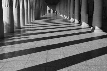 ATHENS, GREECE - OCTOBER 14, 2015: Man walking among the columns of stoa attalos at the ancient...