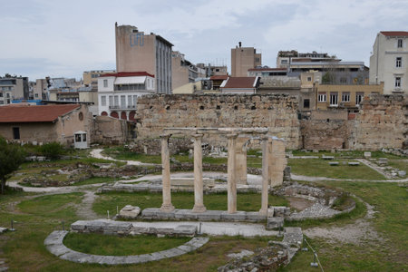 ATHENS, GREECE - APRIL 24, 2015: Columns at the ancient agora and modern city buildings.のeditorial素材